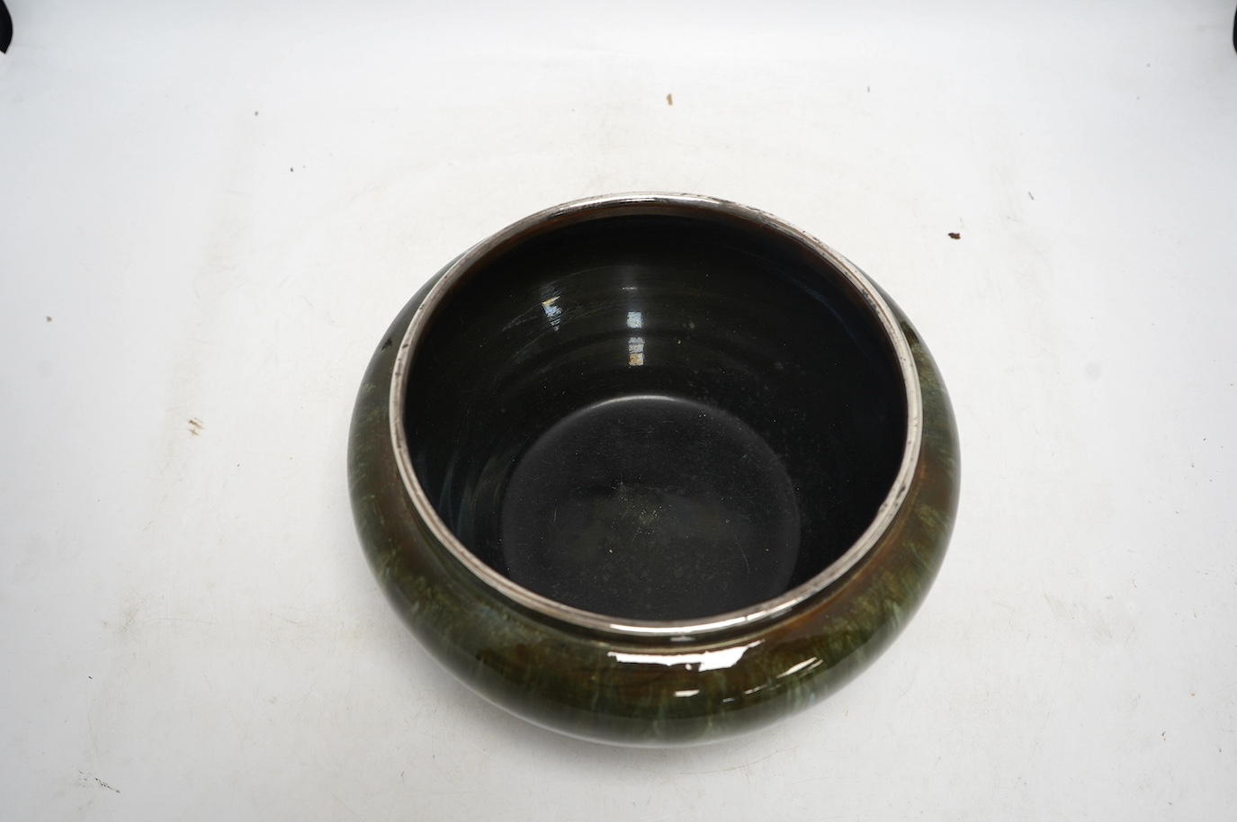 A Christopher Dresser for Linthorpe pottery bowl, silver rimmed, stamped to the base, 24cm in diameter. Condition - good